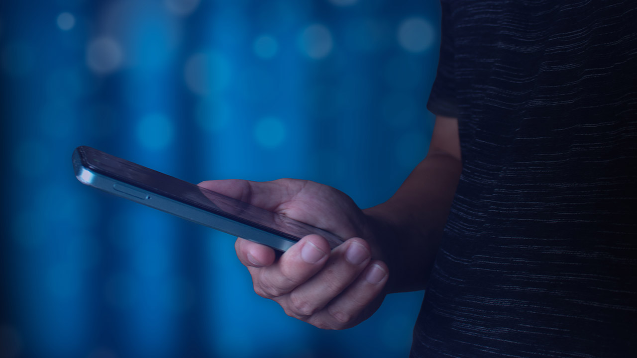 teenage boy holding a mobile