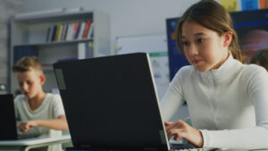 girl on a laptop in a classroom
