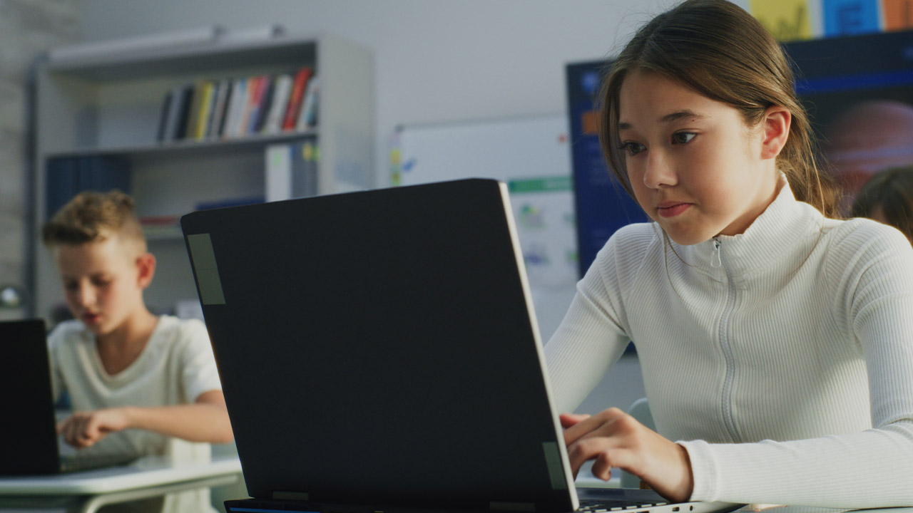 girl on a laptop in a classroom